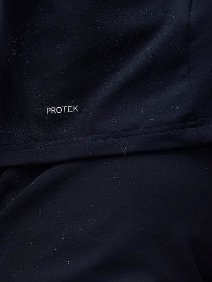 Close-up of navy jacket fabric showing PROTEK branding with water droplets on the surface