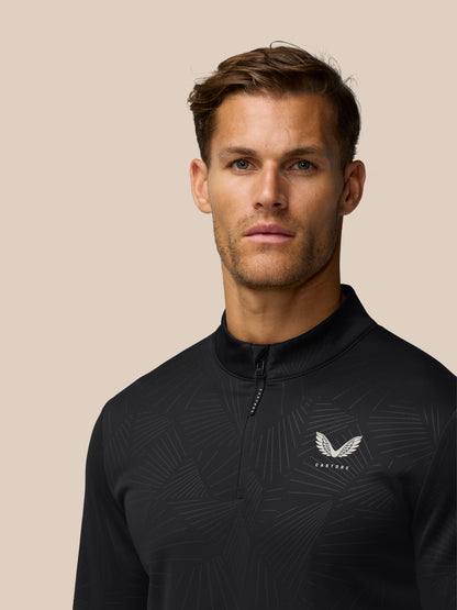 Male model wearing black Golf Club Classic quarter-zip top with a subtle line pattern and Castore wing logo on the chest.