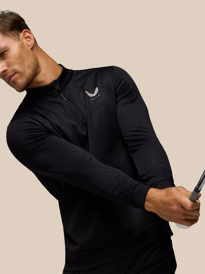 Close-up of male model wearing black Golf Club Classic 1/4 Zip Debossed Top with subtle print and Castore logo on chest.