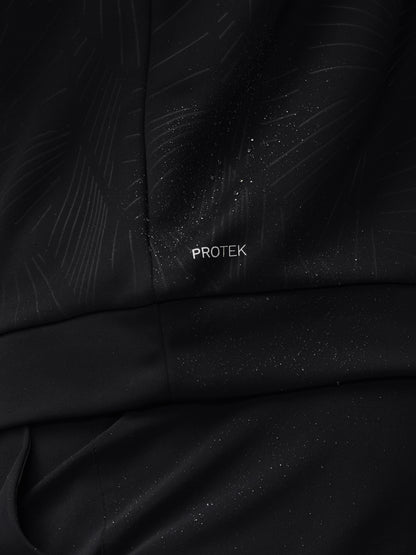Close-up of black fabric with a subtle diagonal print, water droplets, and PROTEK branding on a golf top.
