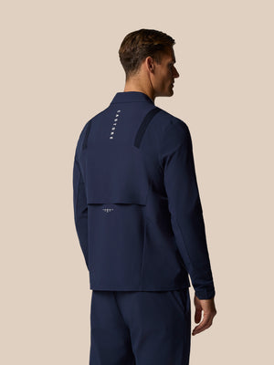 Back view of navy Golf Pinnacle LVS Jacket showing vertical Castore branding and shoulder ventilation panels