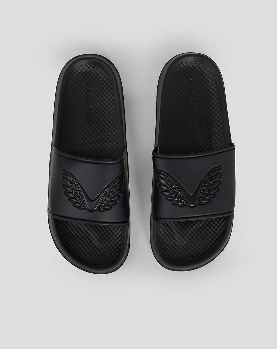 Top view of black Castore sliders showing embossed wing emblems on the straps and the word logo along the sides