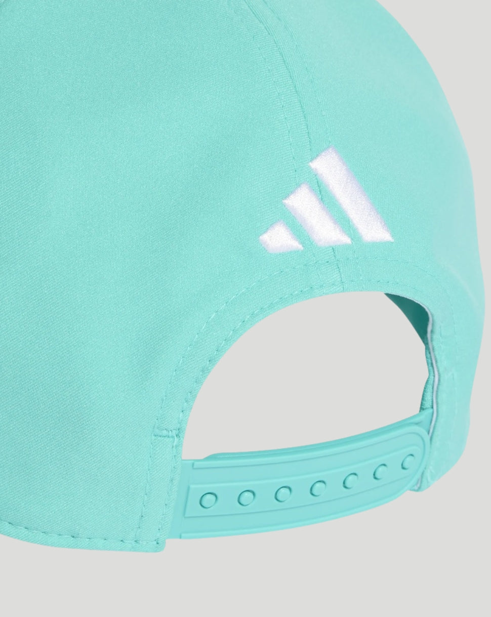 Close-up of a turquoise cap with Adidas logo on a light gray background