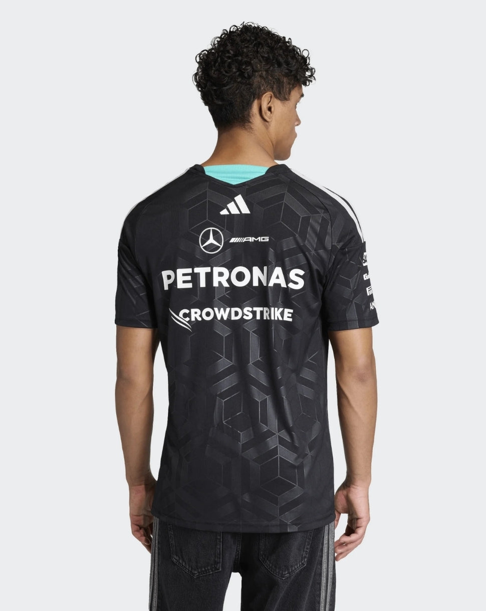 Back view of a black Mercedes AMG Petronas driver T shirt with large Petronas and CrowdStrike logos on the back and a turquoise neck trim.