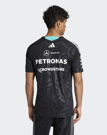 Back view of a black Mercedes AMG Petronas driver T shirt with large Petronas and CrowdStrike logos on the back and a turquoise neck trim.