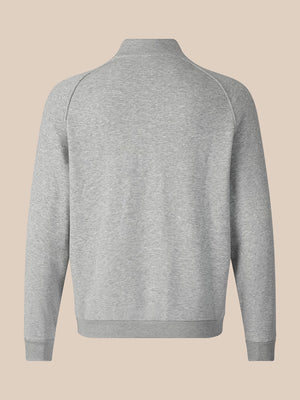 A light gray heathered long-sleeve quarter-zip sweatshirt shown from the back, featuring a mock neck and ribbed cuffs and hem, set against a solid beige background.