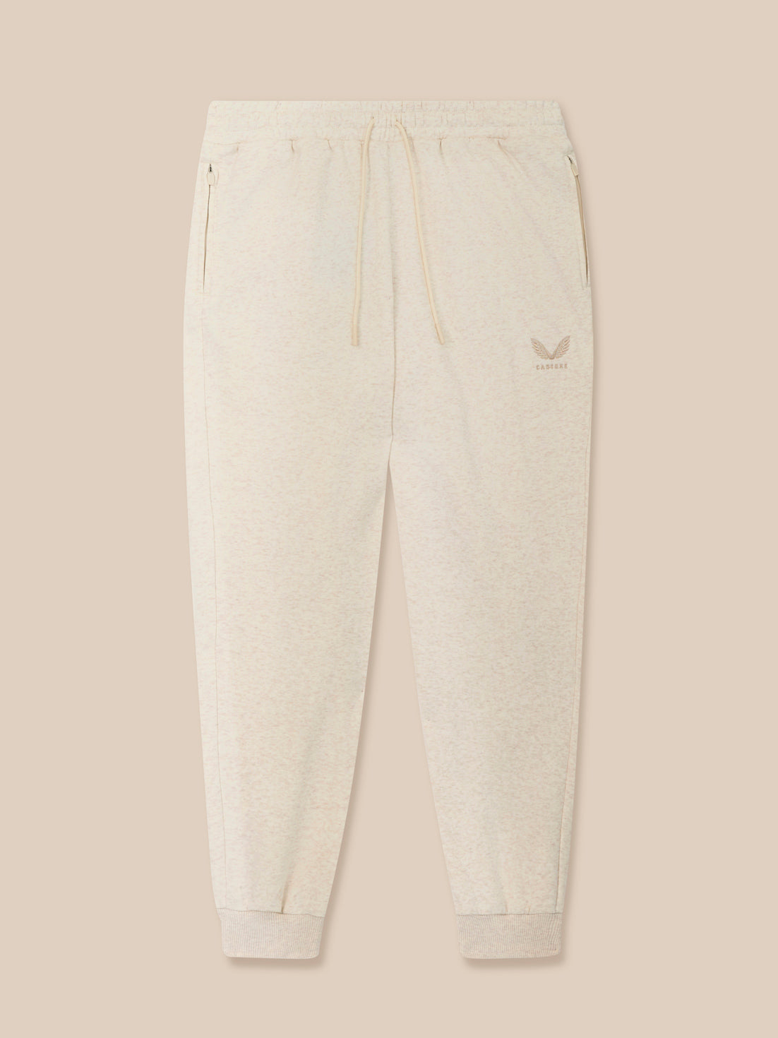 Cream Men's Adapt Cotton Fleece joggers with elastic waistband drawcord, zip pockets and Castore logo on the thigh.