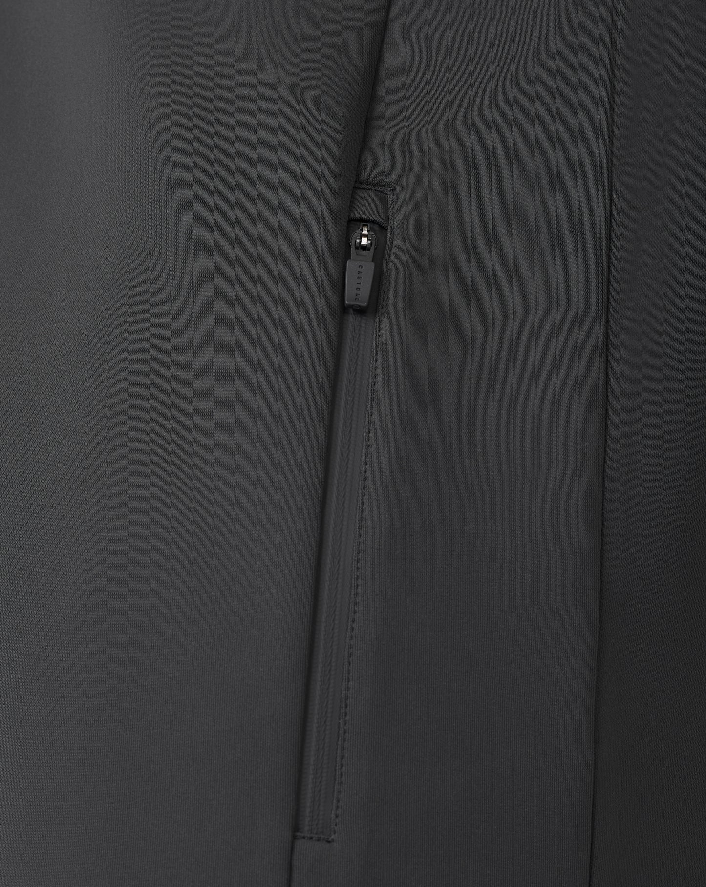 Close up of black zip detail on a quarter zip sweatshirt with visible zipper pull