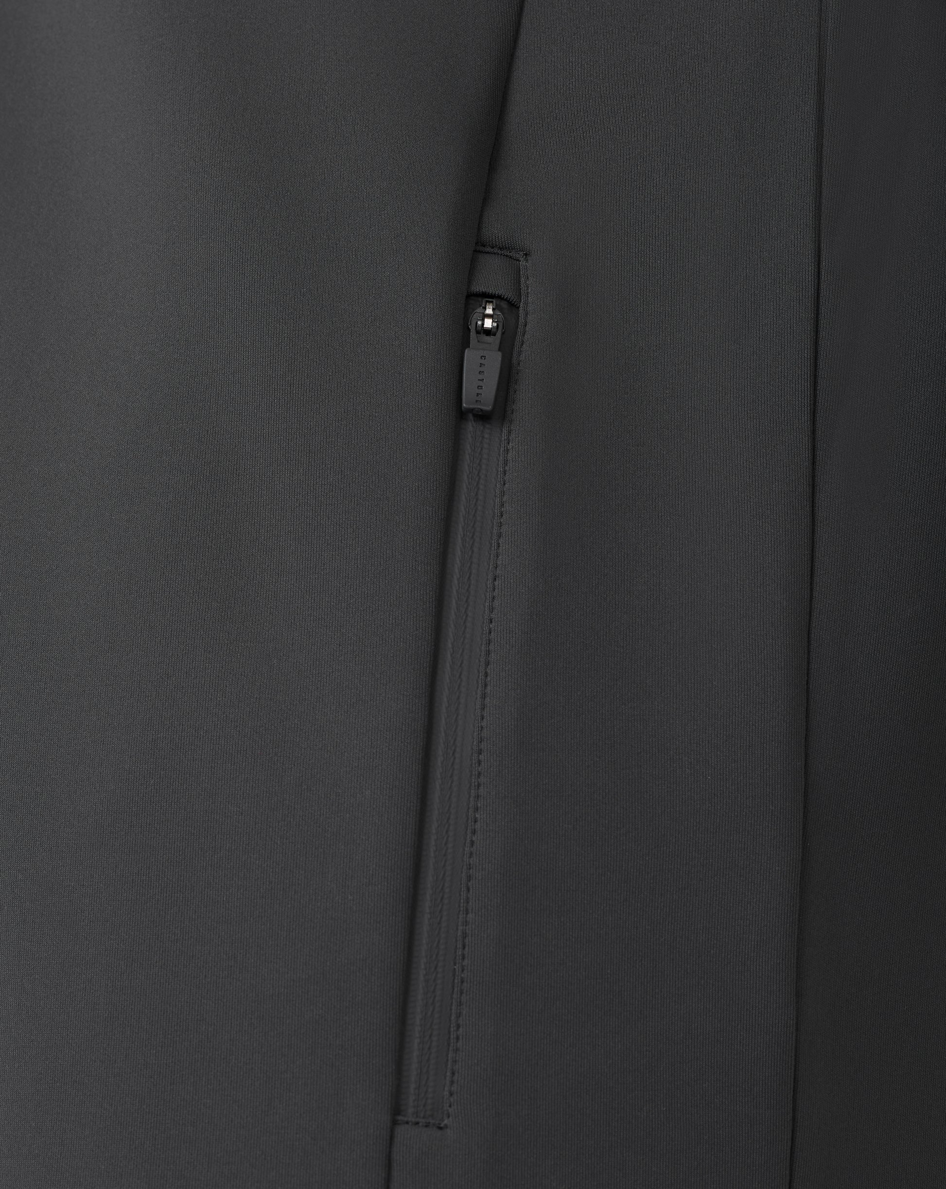 Close up of black zip detail on a quarter zip sweatshirt with visible zipper pull