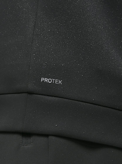 Close up of black ProTek fabric with water droplets and branding on the chest area