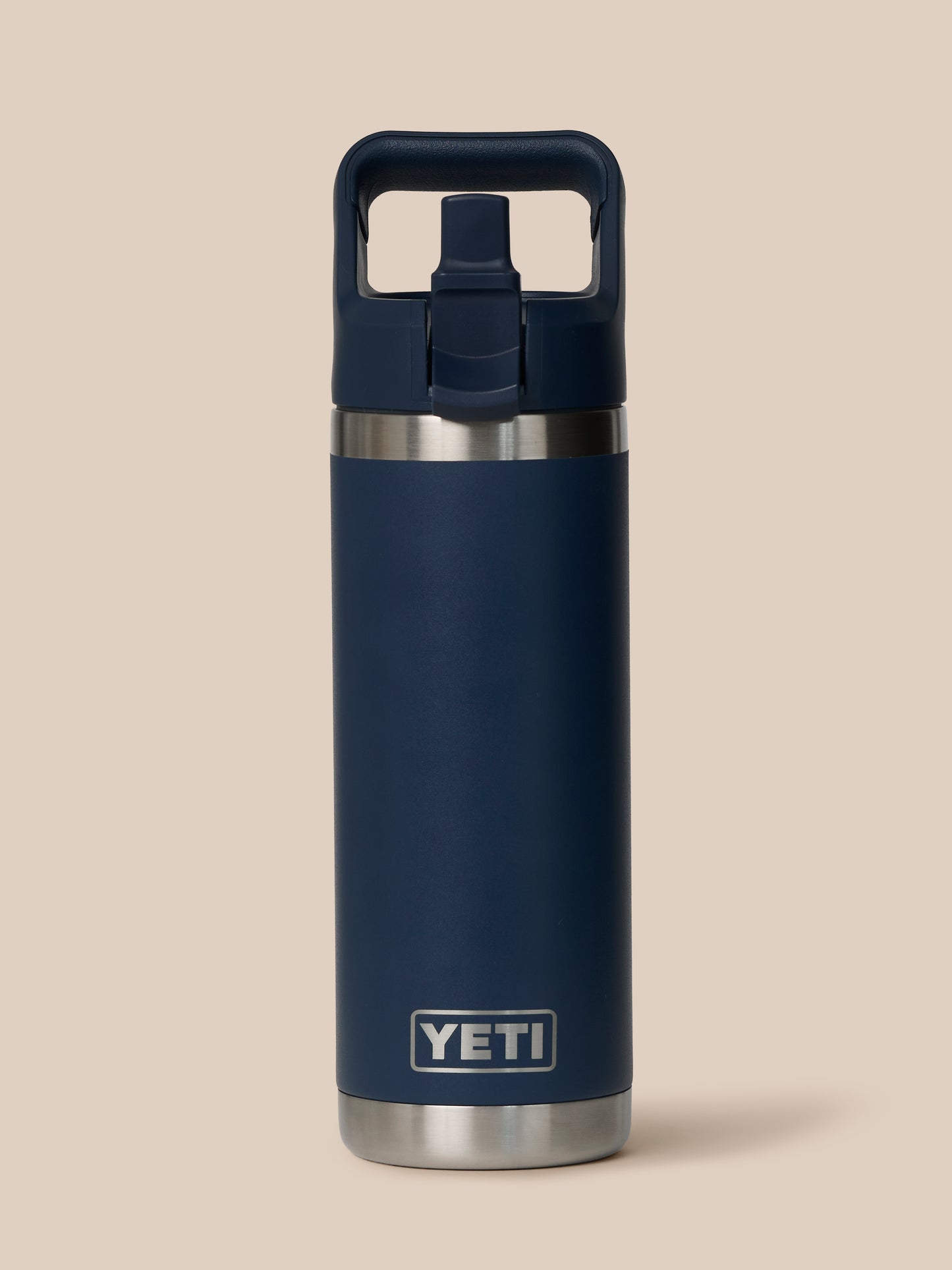 Close up of YETI Rambler 532 ml bottle with leakproof Chug Cap and built in handle against a beige background