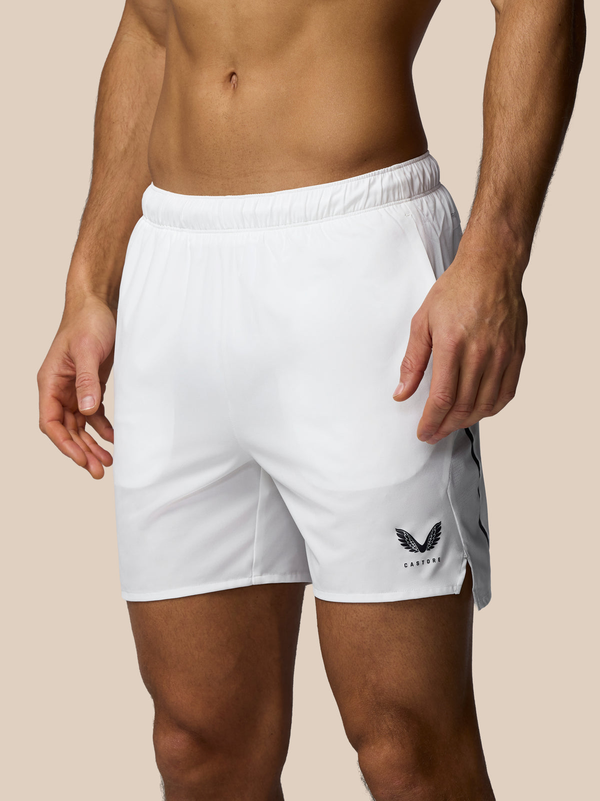 White athletic shorts with a logo on a beige background