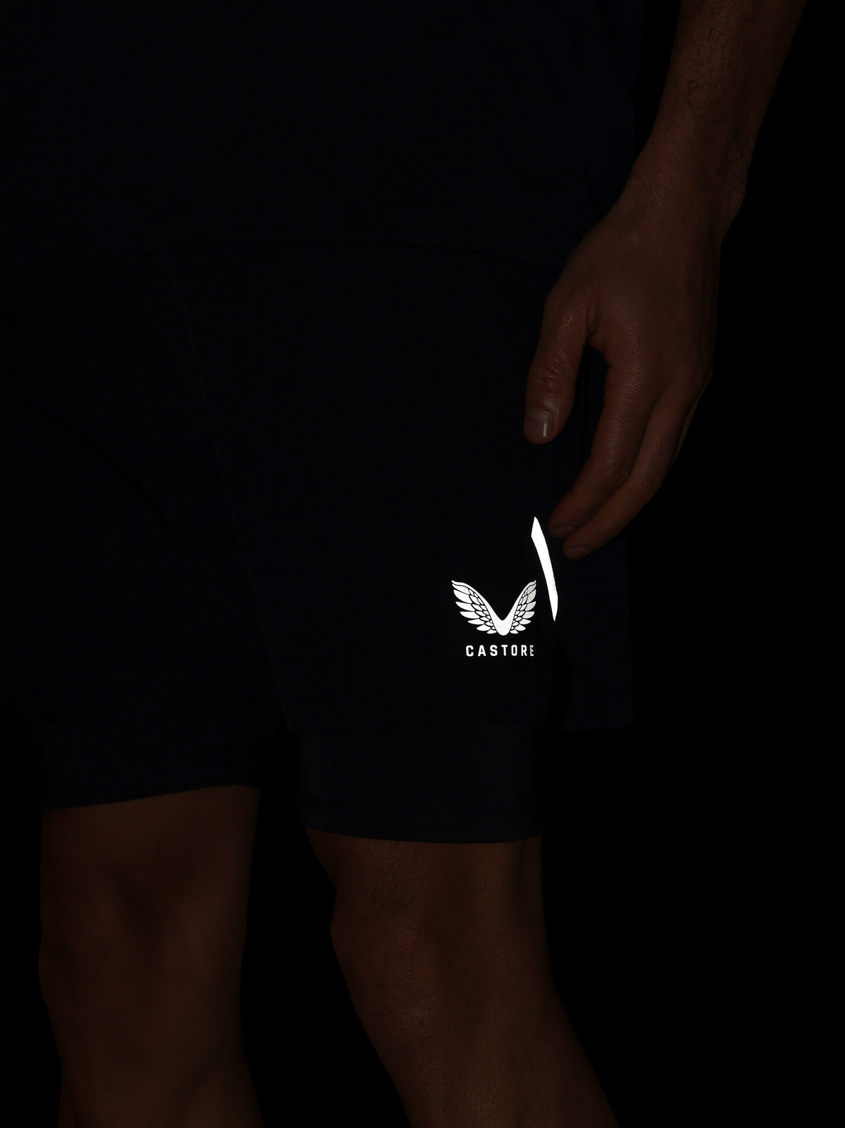 Black shorts with a white logo on a dark background