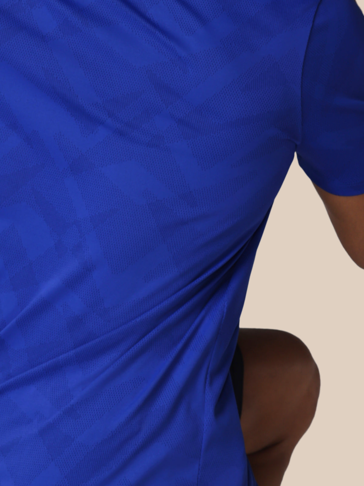 Close-up of a blue fabric with a beige background