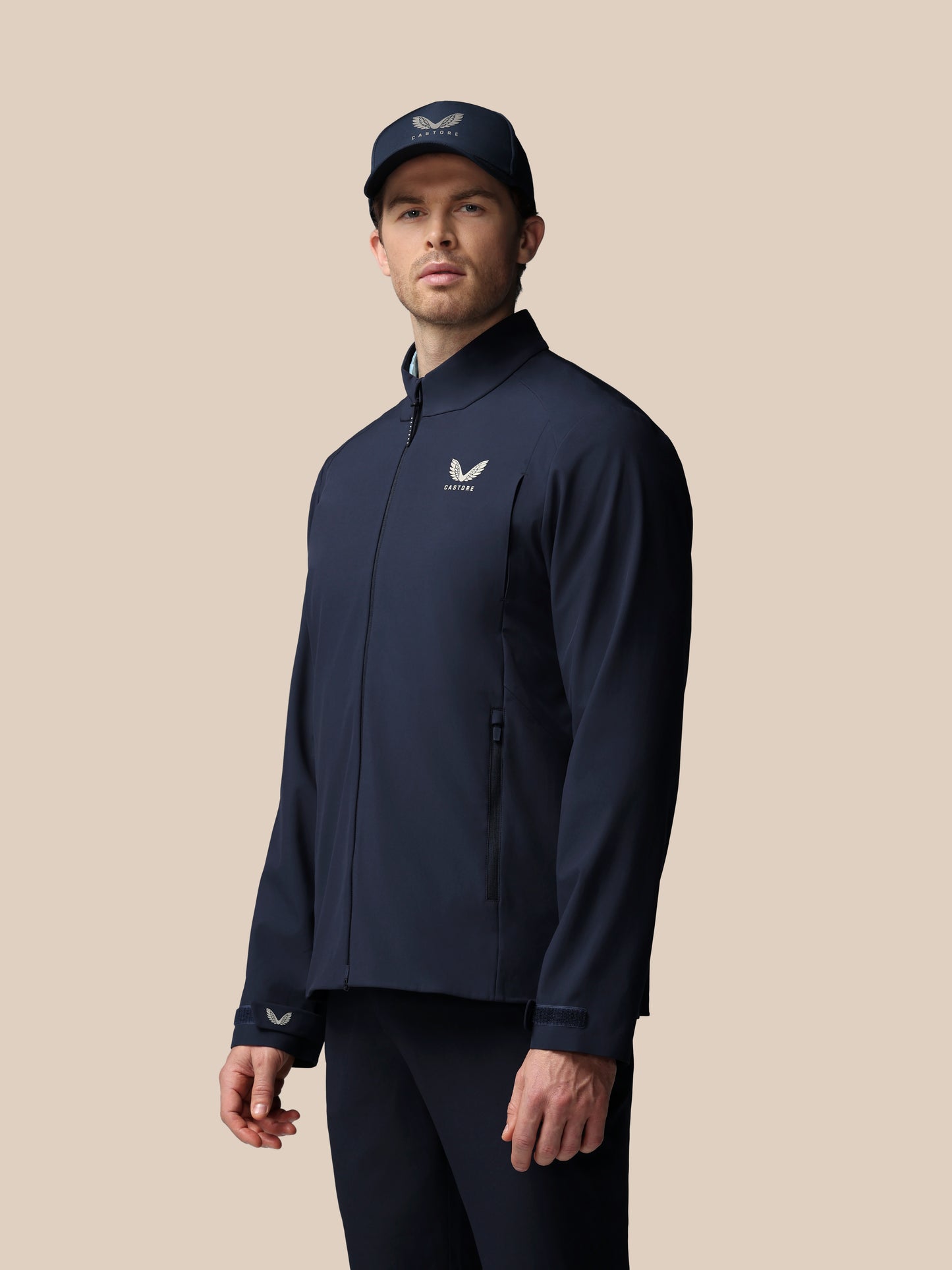 Man in navy Castore LVS woven jacket with front zipper and chest logo