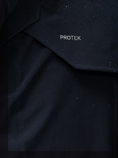 Close-up of navy jacket fabric with PROTEK branding