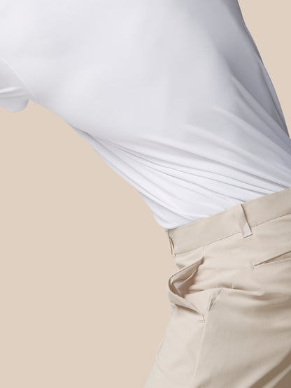Close-up of white golf trousers fabric showing a fine weave and curved seam.