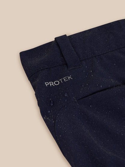 Close up of navy golf trousers waistband area with ProTek branding and zipper detail
