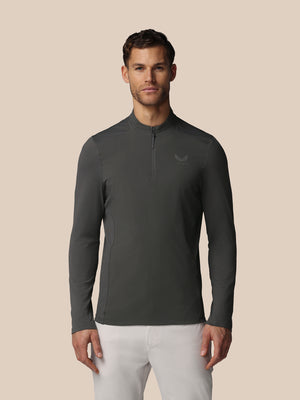 Front view of a man in gunmetal LVS Quarter Zip Long Sleeve Top with a zip collar and Castore logo on the chest.