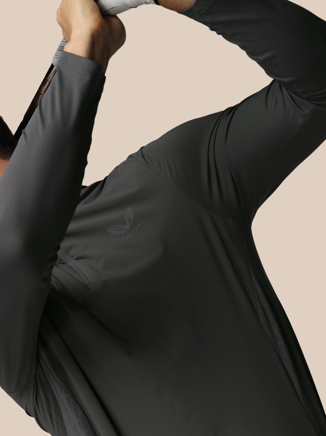 Close up of a male model wearing gunmetal LVS quarter zip golf top showing textured side panels and ventilation details