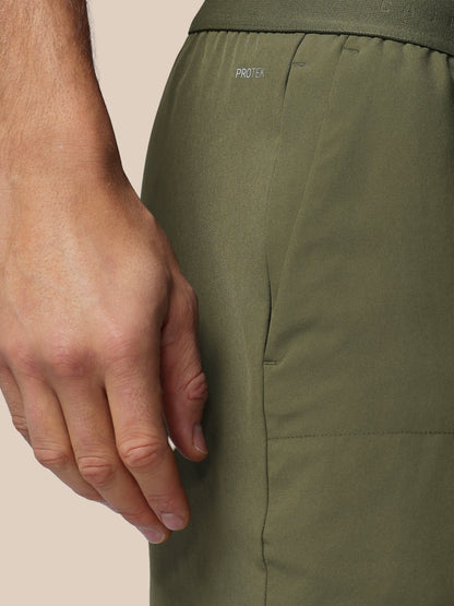 Close up of olive green Adapt 5 inch shorts waist area showing ProTek branding and elastic waistband