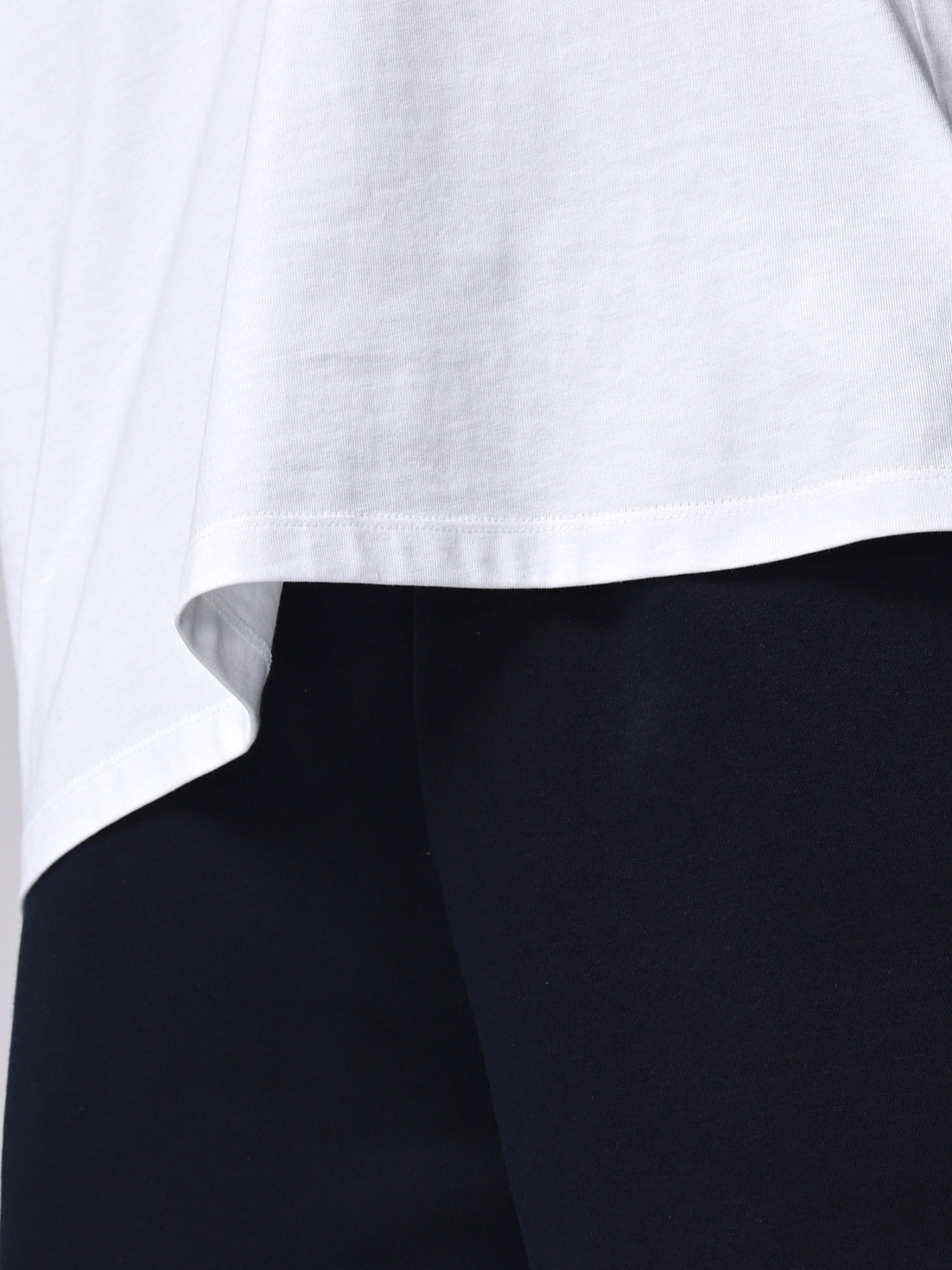Close-up of a white shirt collar with black fabric underneath