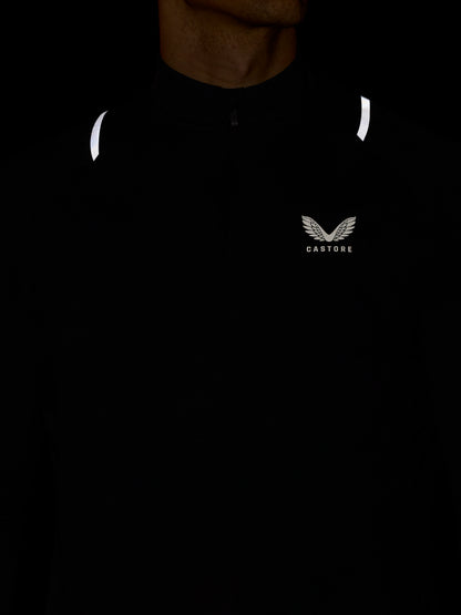 Black men's Apex training top with center quarter zip, reflective shoulder hits, and Castore logo on the left chest