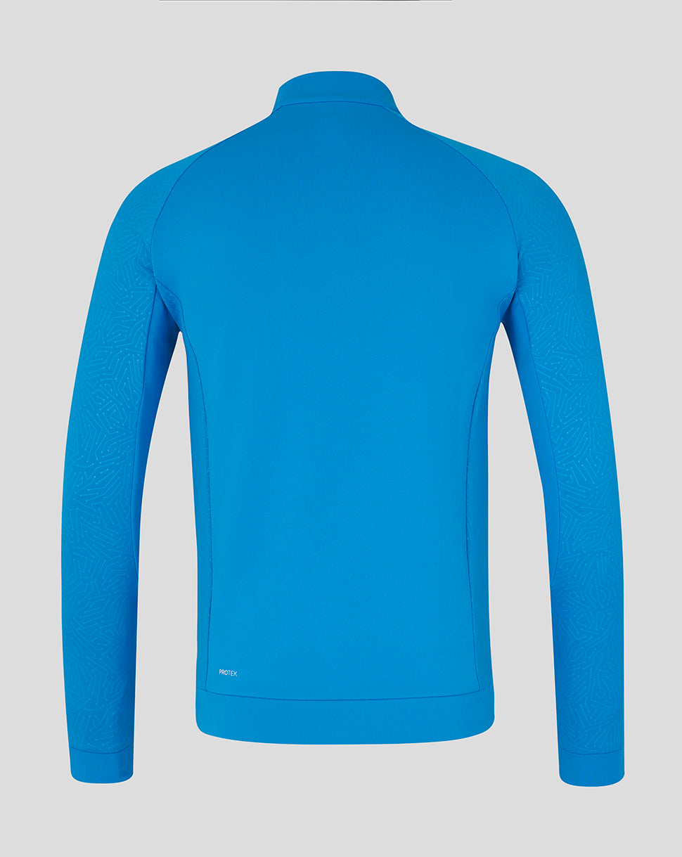 Back view of bright blue Majesticks golf club long sleeve flex top with stand collar and ProTek label at back hem.