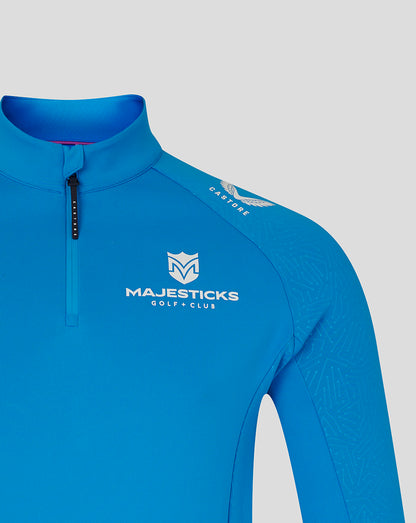 Close-up of blue Majesticks golf club top with Majesticks logo on chest and Castore crest on shoulder.