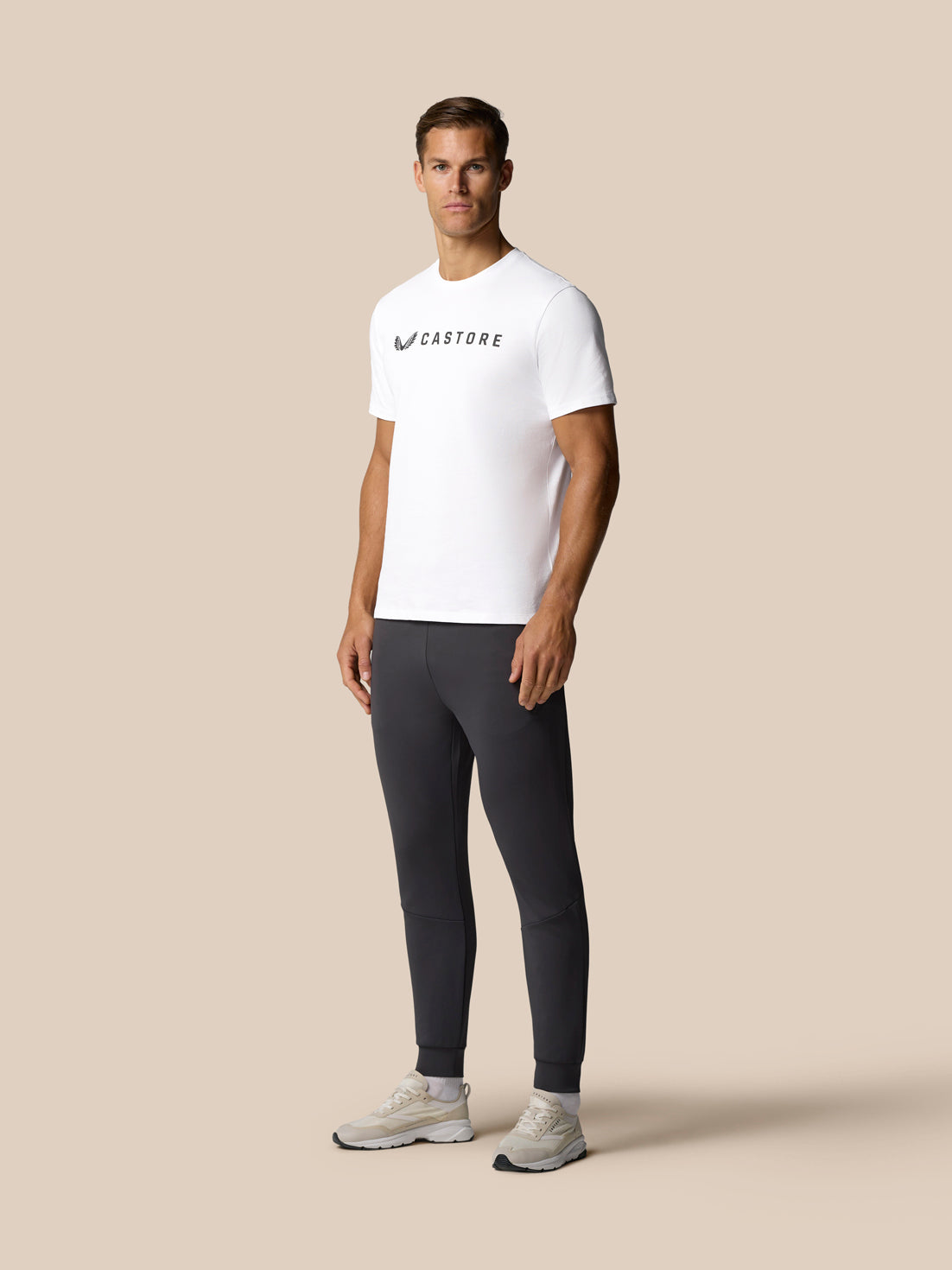 Back view of a man in a white Castore graphic T shirt.