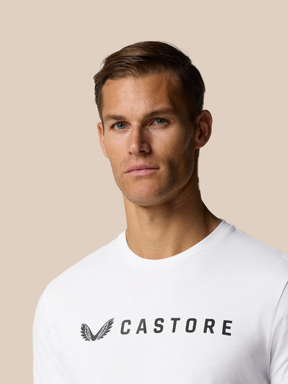 Head and shoulders shot of a male model wearing a white Castore Graphic Lifestyle T-Shirt with the Castore wordmark across the chest