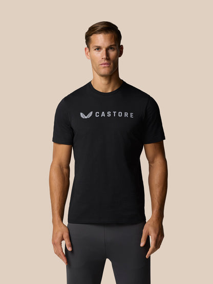 Close-up of a man wearing a black Castore T-shirt with a chest logo.