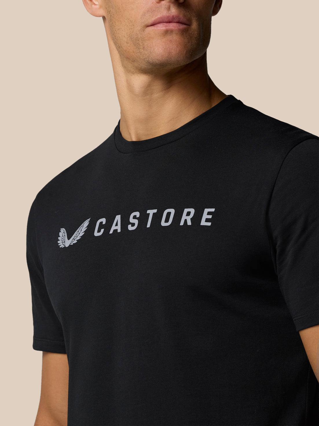 Close-up of the Castore logo and wordmark on a black T-shirt