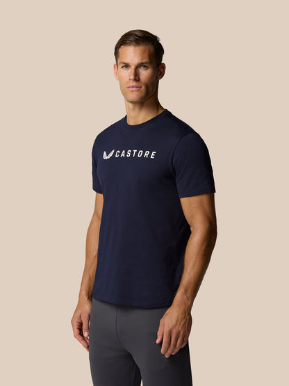 Male model wearing navy Castore graphic lifestyle T-shirt with round neckline and front wordmark