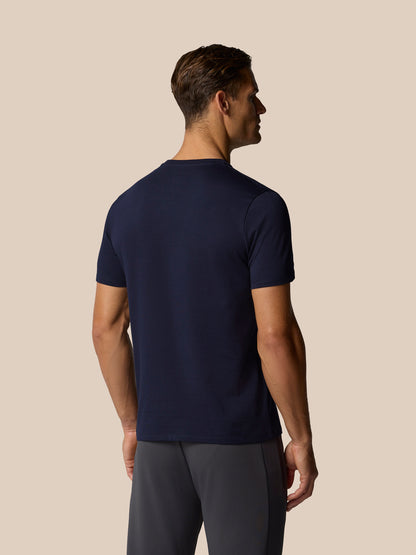 Back view of male model wearing navy Castore graphic lifestyle T-shirt