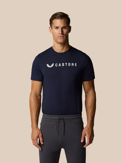 Front view of male model in navy Castore graphic lifestyle T-shirt with front wordmark