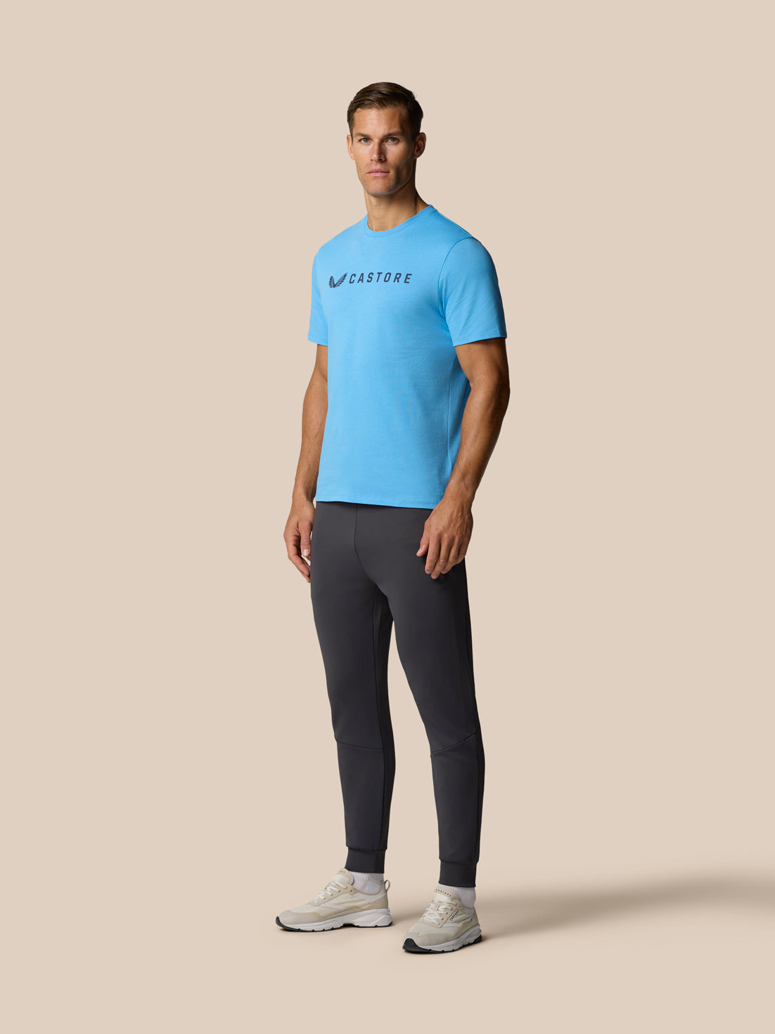 Back view of man wearing blue Castore graphic lifestyle T-shirt