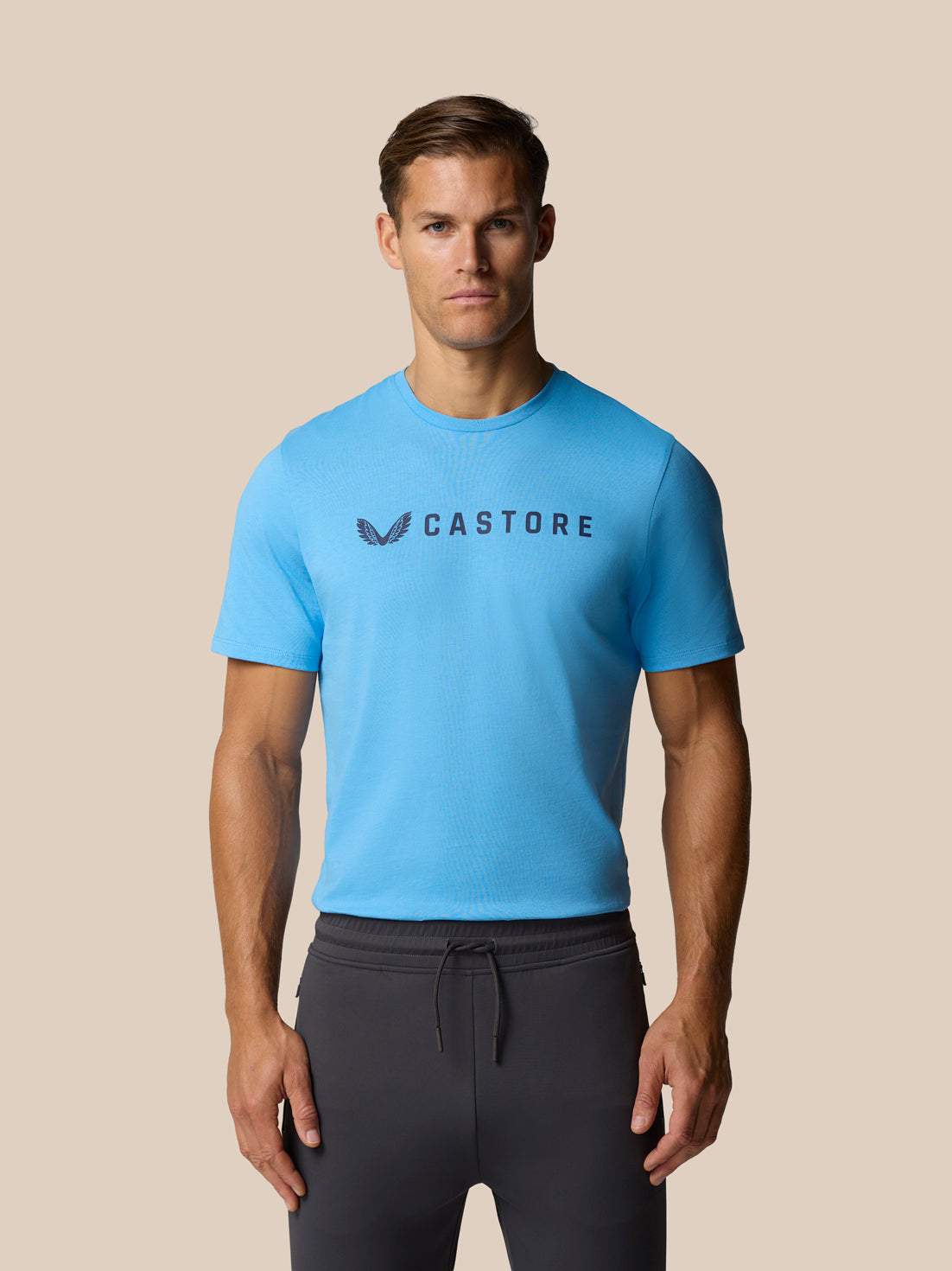 Man wearing cool blue Castore graphic lifestyle T-shirt with front logo