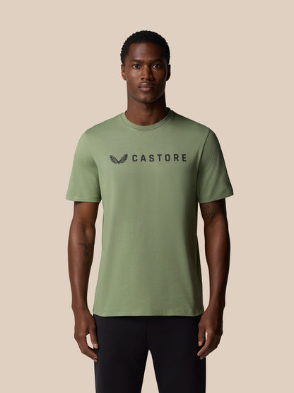 Thyme green graphic lifestyle T shirt with Castore wordmark across the chest worn by a male model.