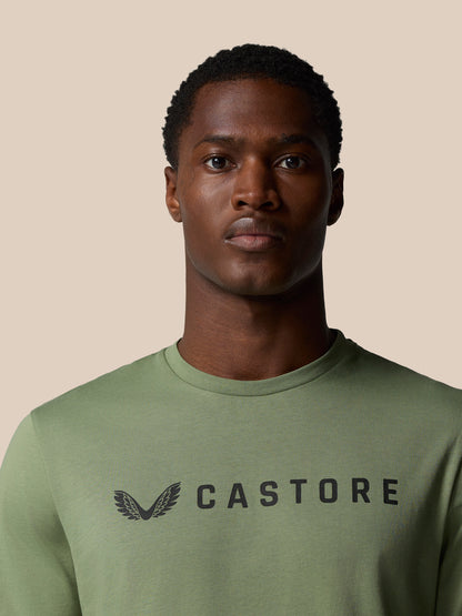 Close-up of the thyme green Castore Graphic Lifestyle T Shirt showing the Castore wordmark on the chest.