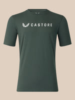 A dark green crewneck t-shirt with a white Castore logo printed on the chest, displayed against a solid beige background.