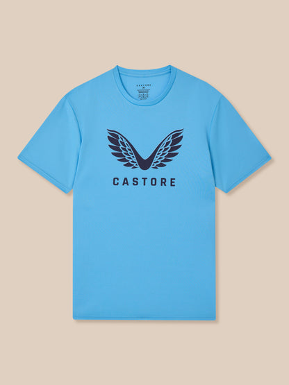 Torso-focused shot of a model in a light blue Castore Graphic Training T-Shirt showcasing the wing logo centered on the chest.