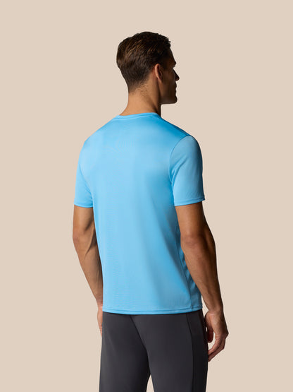 Back view of a man wearing a light blue graphic training T shirt