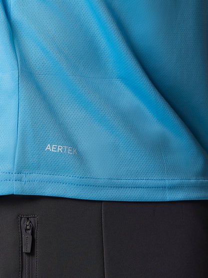 Close up of blue AerTek knit fabric with seam detail and a black zip pocket visible below