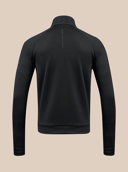 A black long-sleeve quarter-zip pullover shown from the back, featuring a high collar and a small vertical brand text print on the upper back, set against a solid beige background.