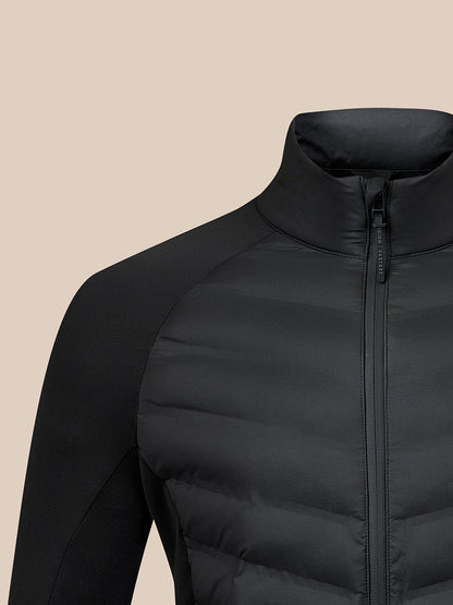 Close-up of a black puffer jacket with a high stand-up collar and front zipper, shown on a plain beige background.