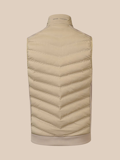 A light beige puffer vest shown from the back on a mannequin, featuring chevron quilting and a ribbed collar, hem, and cuffs.