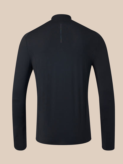 A black long-sleeve athletic quarter-zip pullover shown from the back, featuring a small vertical brand logo on the upper back, set against a solid beige background.