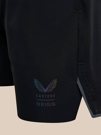 Close up of black fabric on men's Reiss 5 inch deep split shorts with Castore branding near the hem.