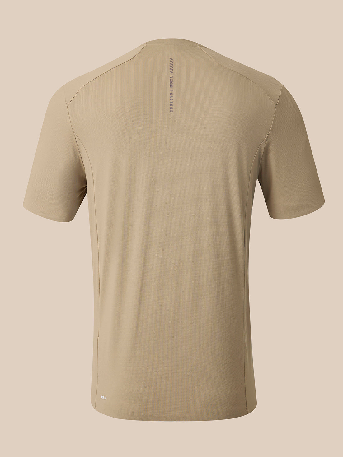 A short-sleeve athletic t-shirt in a light khaki-beige color, shown from the back on a solid beige background. The shirt features a subtle vertical text print on the upper back reading 'REISS CASTORE.